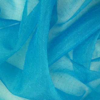 Electric Organza with fine hair like wisps over fabric -